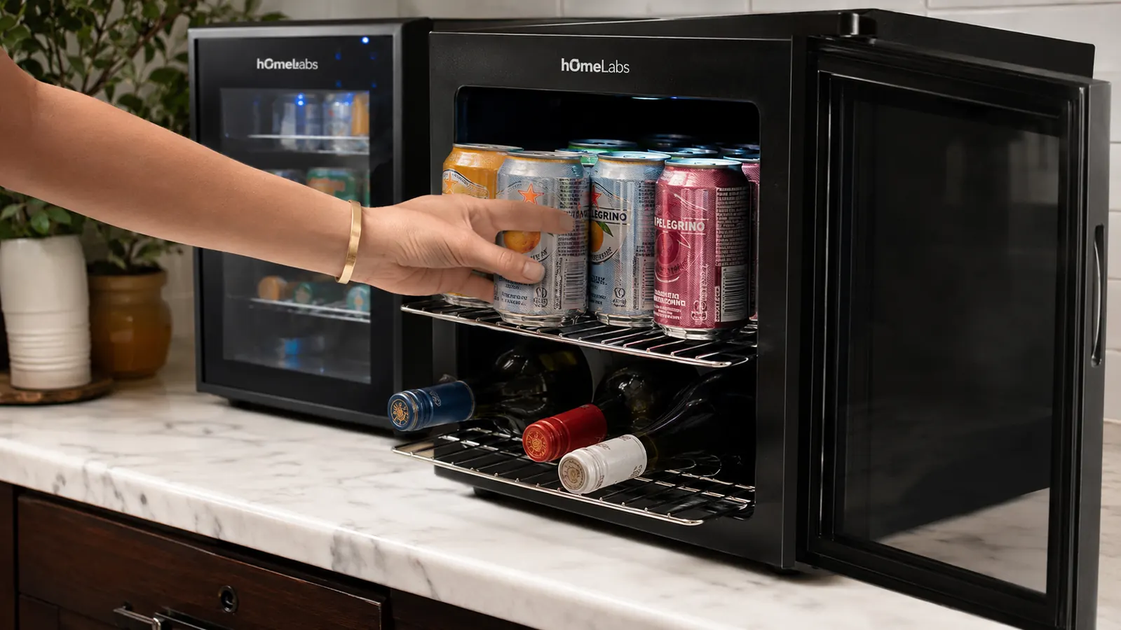 Hand restocking cans onto the sliding shelves of the hOmeLabs beverage fridge during a side-by-side test