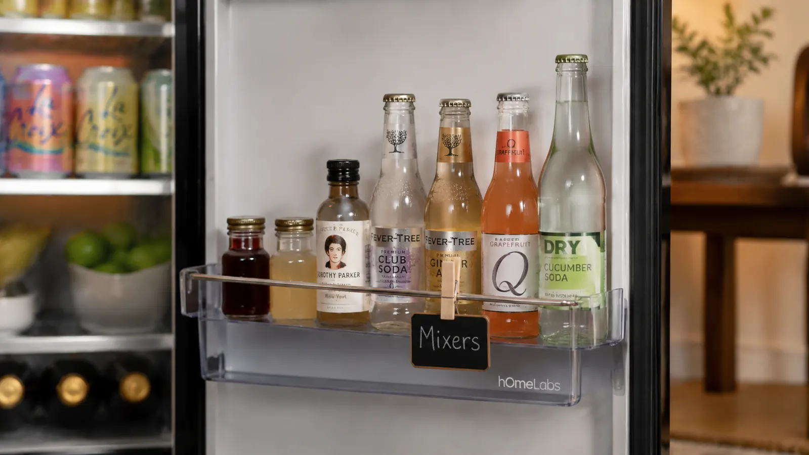 Beverage fridge door shelf lined with condiment bottles and small mixers, sorted by height