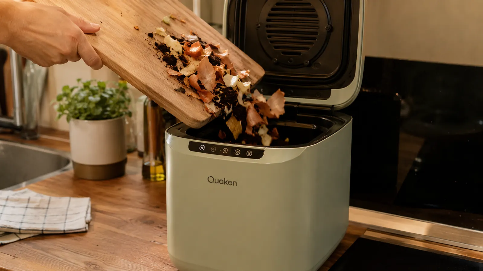 Hand scraping vegetable ends and coffee grounds into the open composter bin